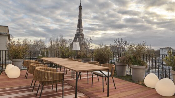 outdoor table and chairs from Ligne Roset on a wooden deck in Paris with view to Eiffel Tower