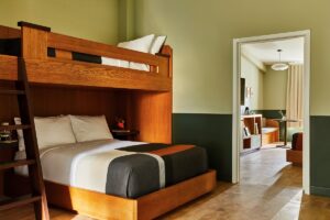 wooden bunkbeds in guestroom designed for family stay