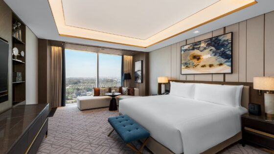 hotel guestroom with bedside table, headboard, bench and shelving from Wood Couture