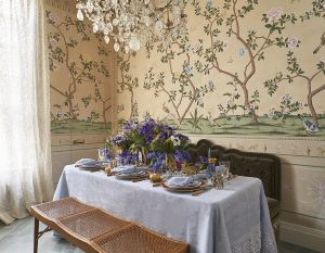 table setting in retail store Bonadea with patterned vintage wallpaper and crystal chandelier