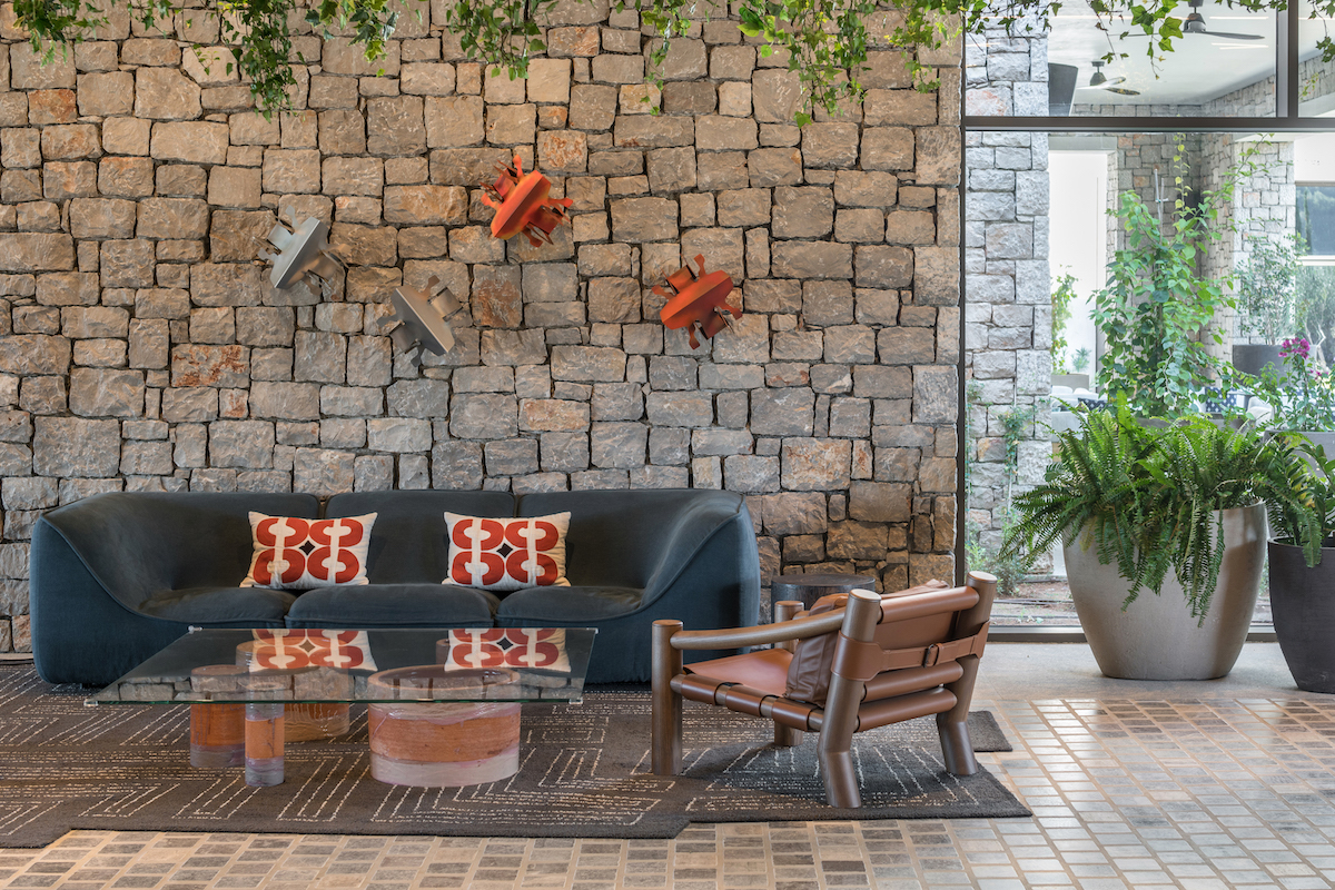 Low-level sofa in lounge of hotel in front of brick wall