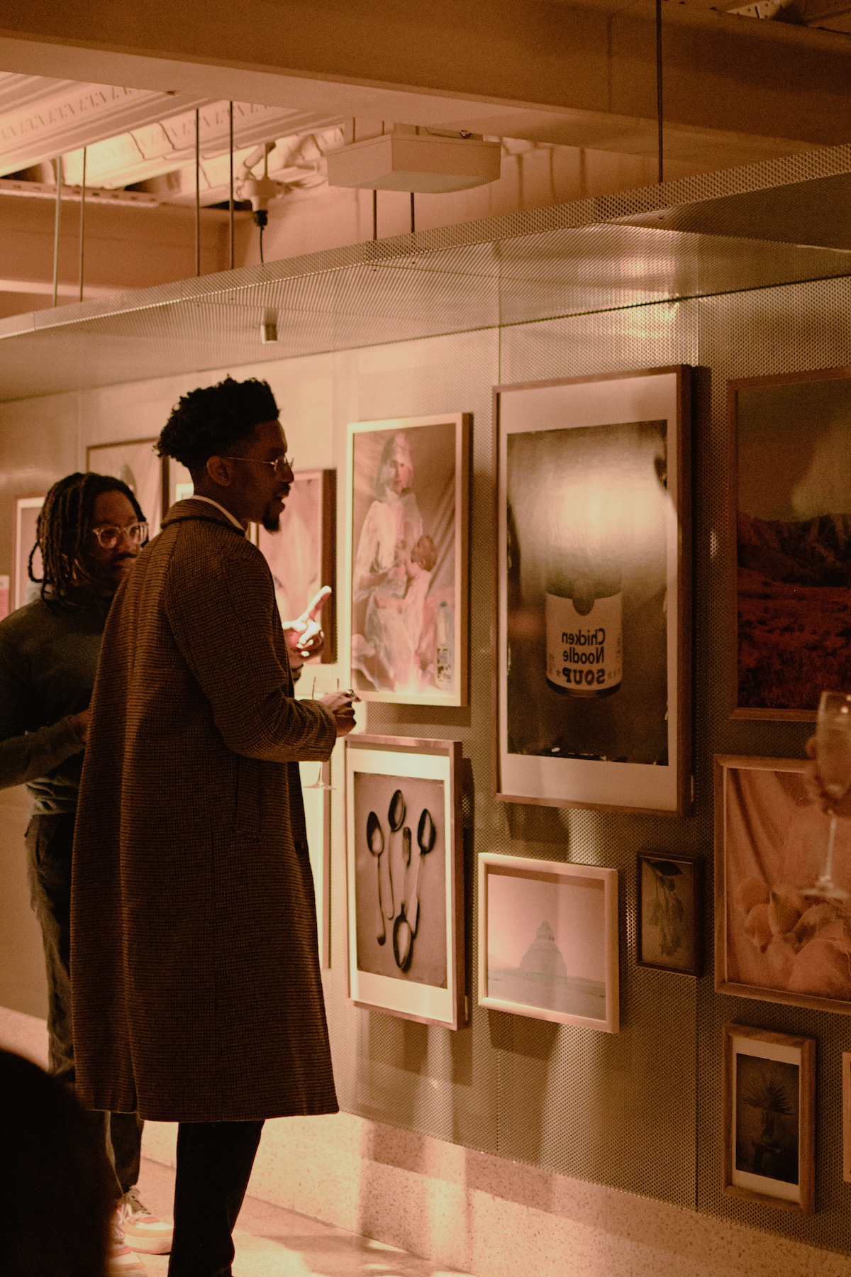 Two men looking at art on wall in gallery