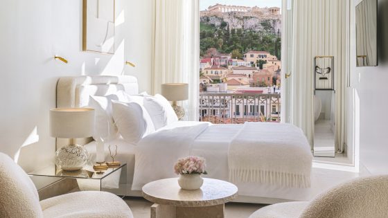 A white suite in luxury hotel in Athens that has a view of the acropolis