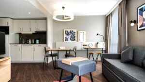 bench seating in blue and open plan kitchen in white with wooden dining table