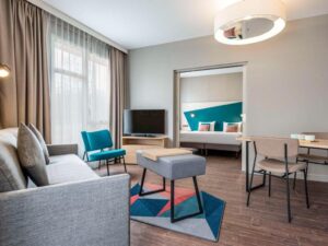 refurbished suite with wooden floors and geometric blue patterned carpet