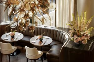 leather banquettes and organic glass chandeliers above dining area