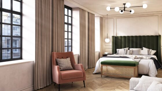 green upholstered headboard in guestroom with pink velvet chair and industrial style windows in The Store Oxford