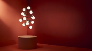 helix chandelier suspended above a plinth in silhouette against a terracotta background