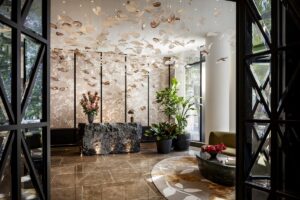 hand blown floating glass petal chandelier in the city lobby of Raffles Boston