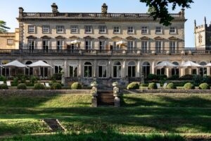 front facade and gardens with umbrellas at Cowly Manor