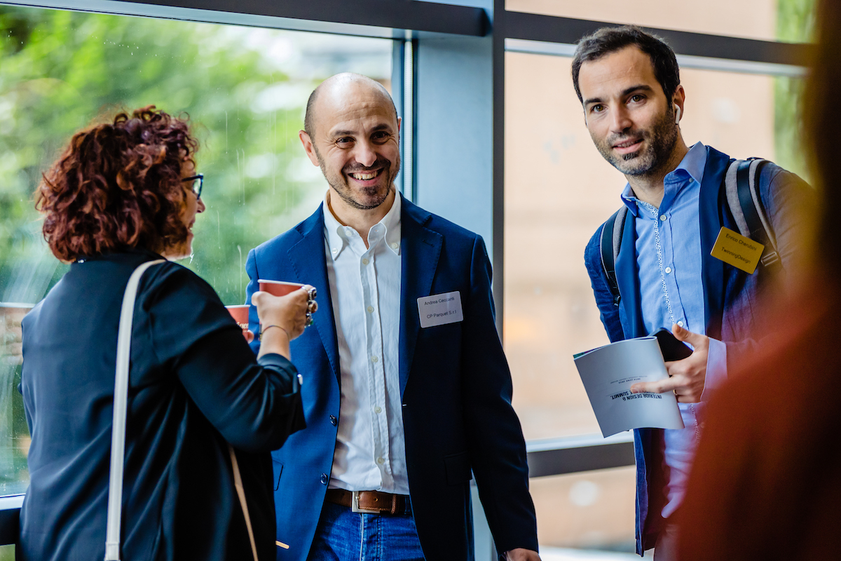 Two men and woman networking