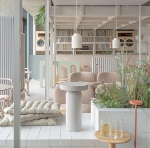 white and cream contemporary interior with blond wood and plants and soft seating on the floor