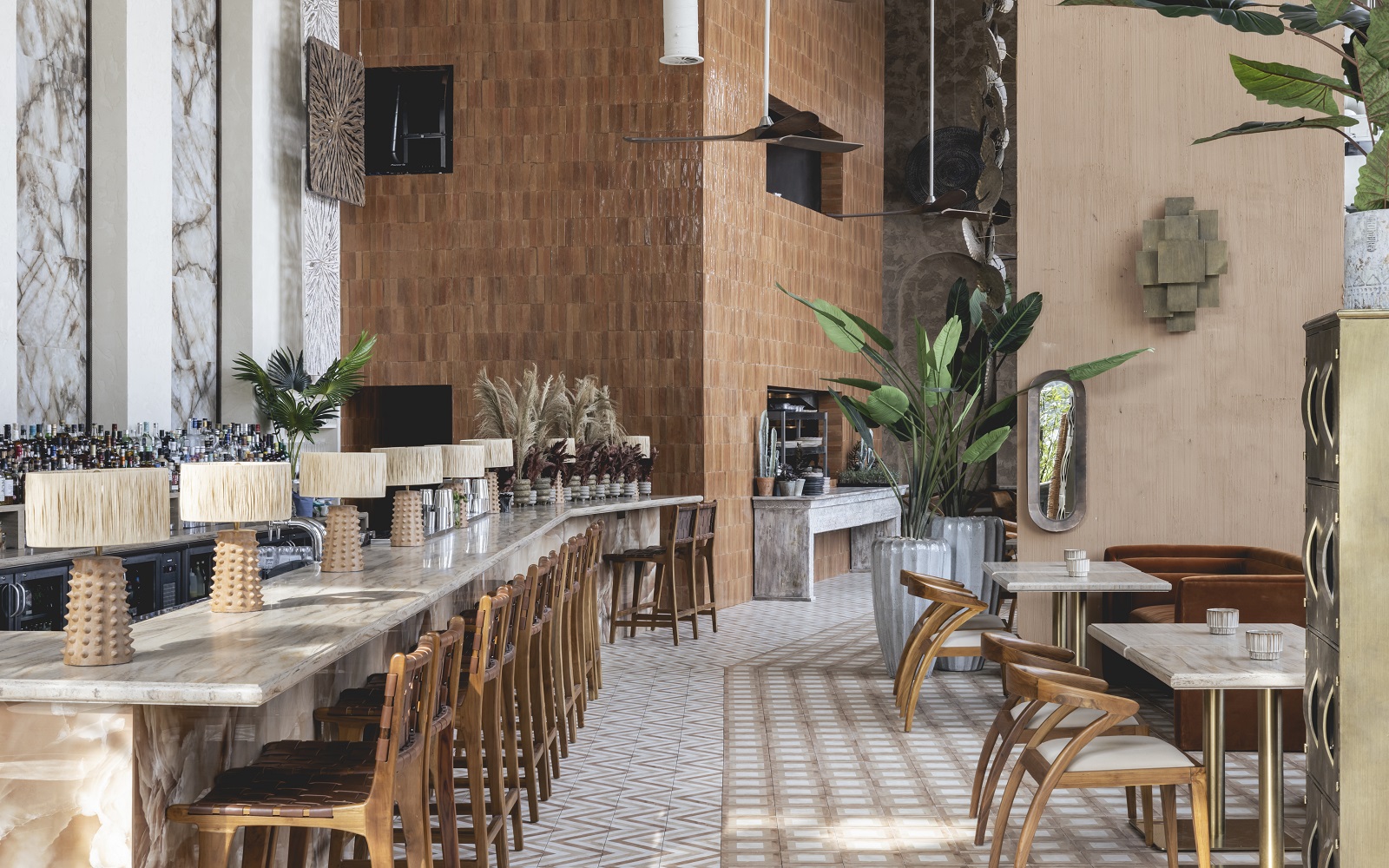 bar with marble surface, wooden bar stools, grass lampshades and textured clay walls in Kitten by Jolie