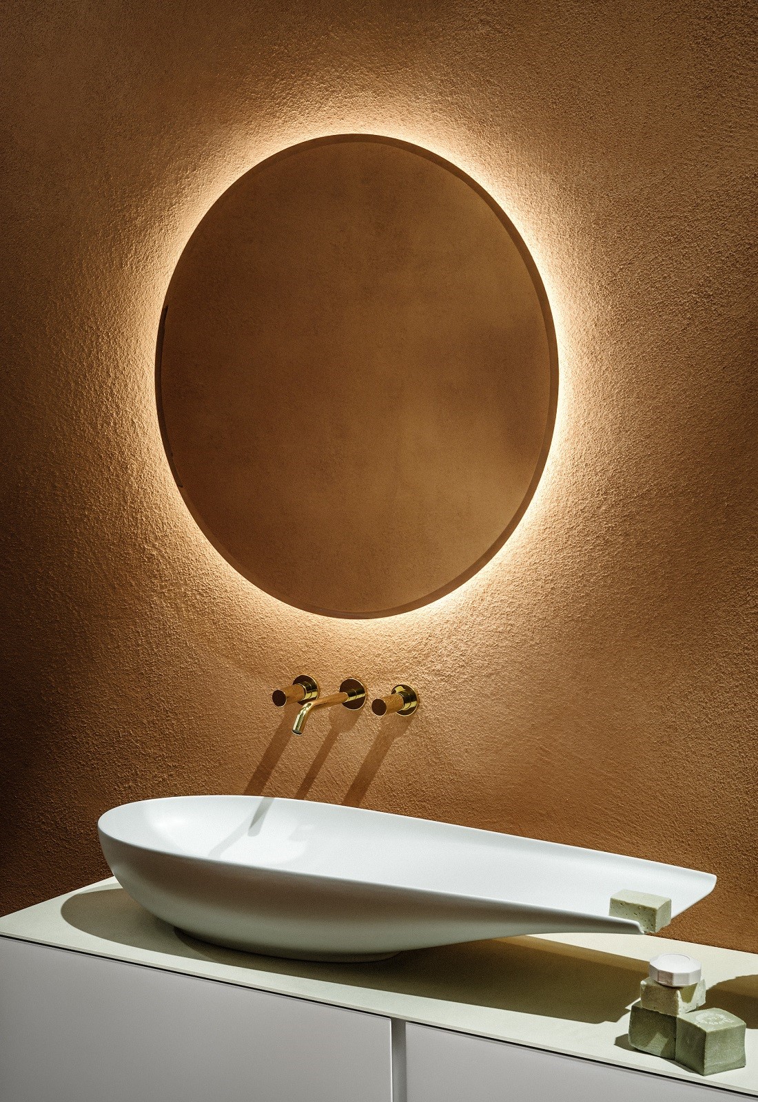 white tuna washbasin from laufen with mirror on terracotta wall