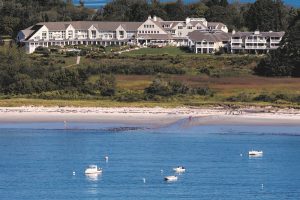 aerial view of seaside hotel, Inn by the Sea, taken from the ocean side with boats in the foreground