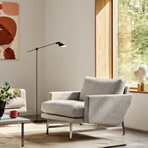 Cream Lissoni chair on cream carpet in front of a window with wooden surround