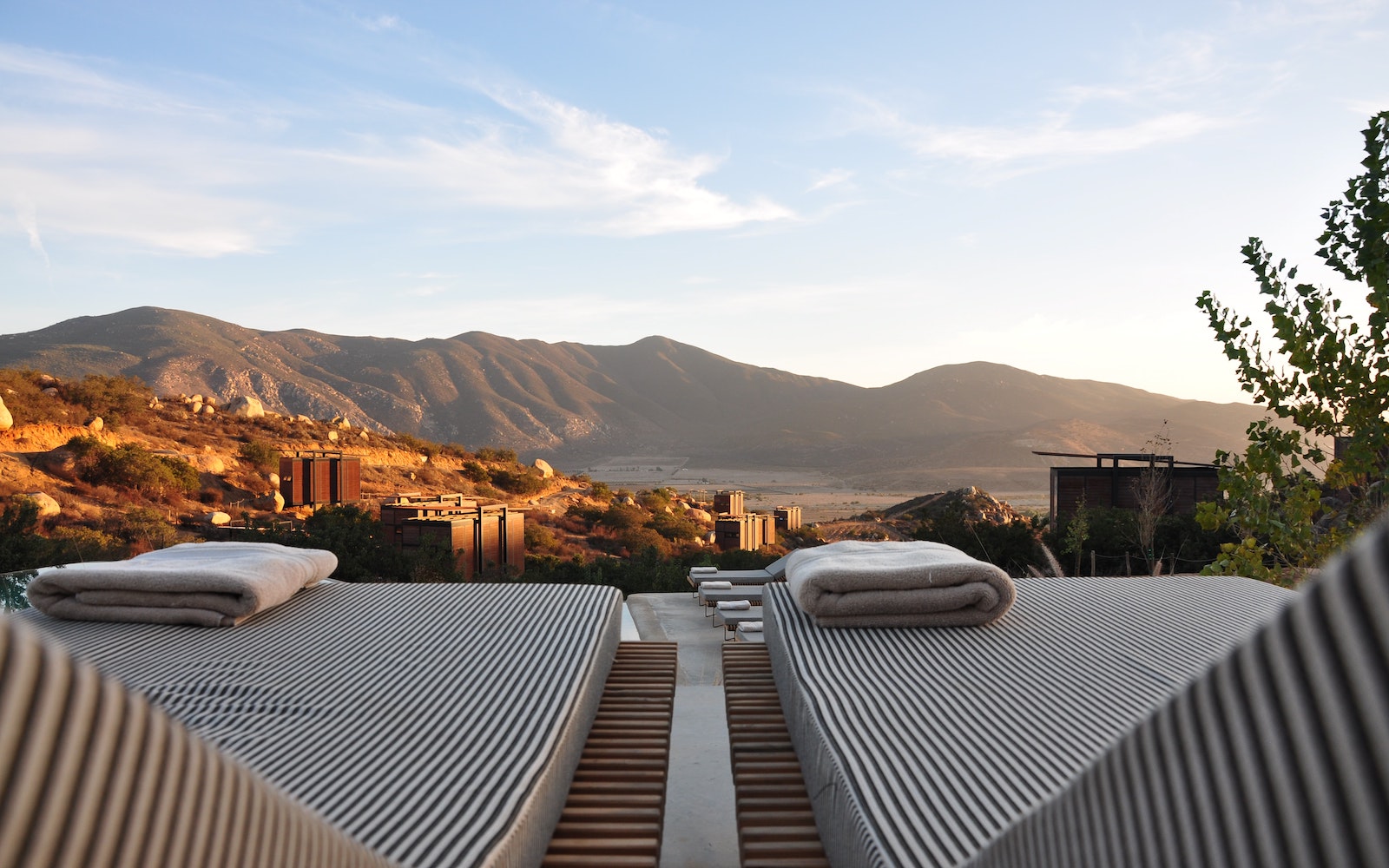 Two sunbeds overlooking mountains