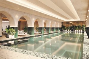 white and green marble and plants around Marriott hotel swimming pool and spa area