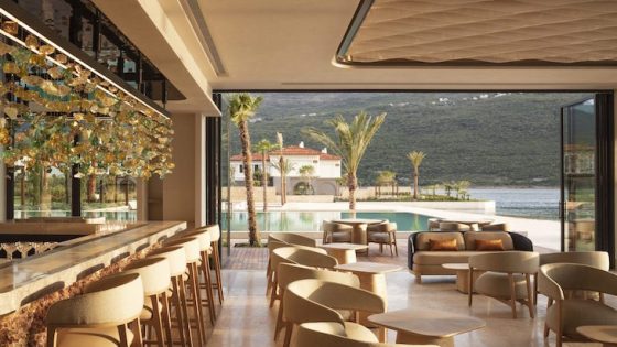 An airy dining area inside One&Only Portonovi overlooking pool and sea