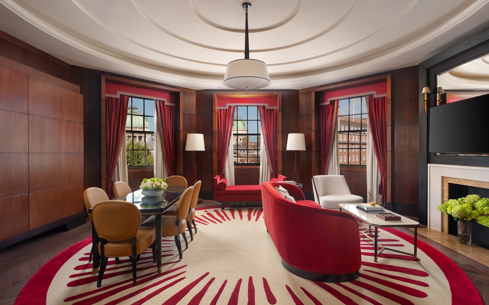 circular red and white carpet, red walls and central bespoke light by Northern Lights in Raffles London OWO Atkins Suite lounge