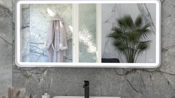 rectangular bathroom mirror from RAk above basin reflecting bathrobe and indoor plant