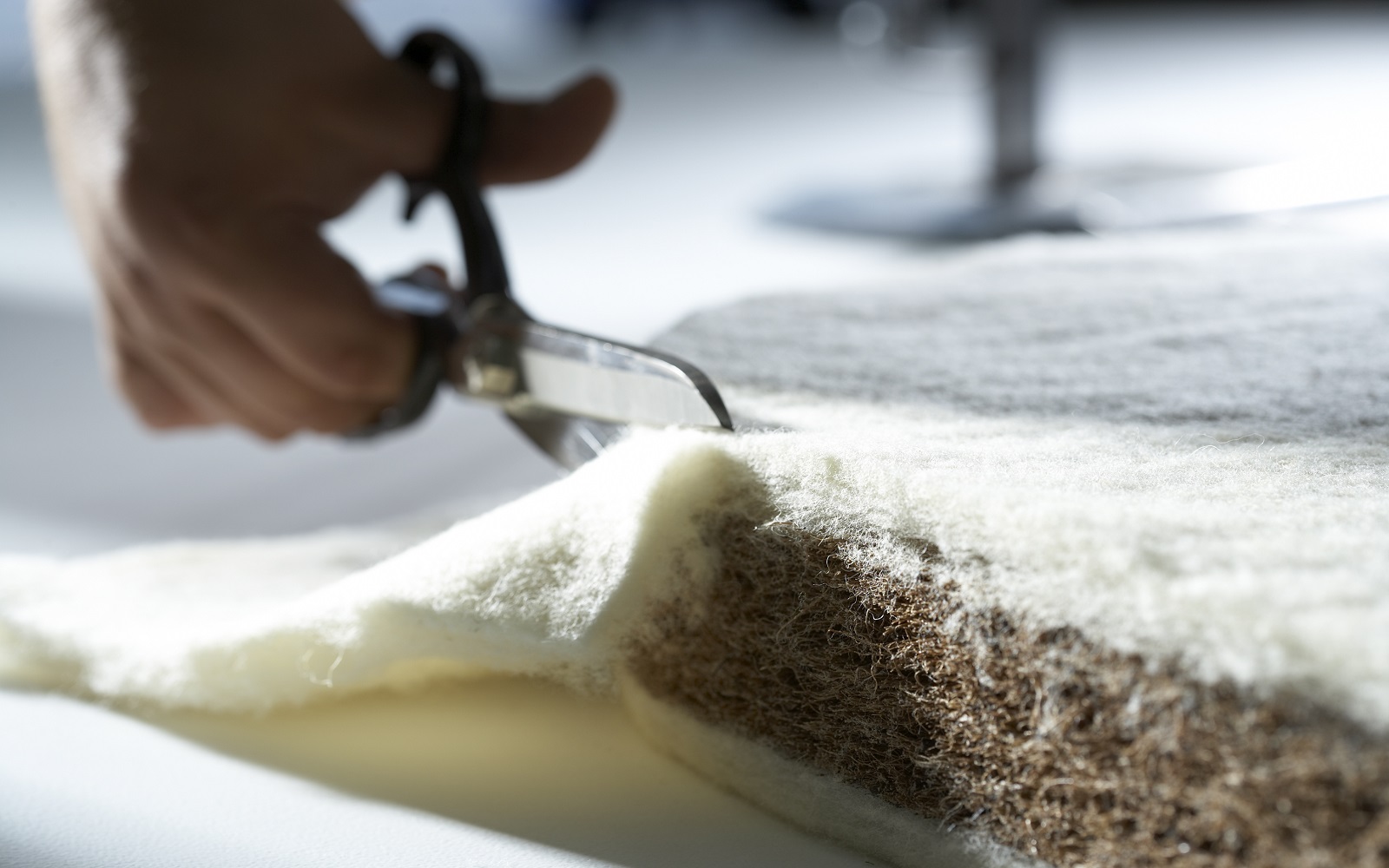 close up image of scissors cutting through Naturalmat product