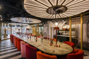 giant disc statement lighting on ceiling above the table in The Rosarium