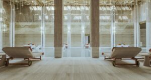 indoor saltwater pool surrounded by marble with filtered light from above