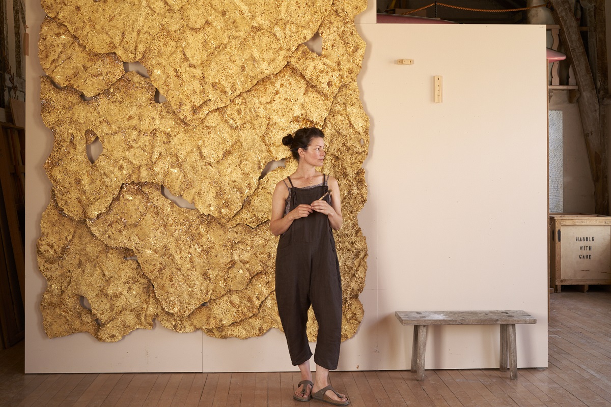 Artist SOPHIE CORYNDON next to her masterpiece that hangs in the lobby at The Dorchester