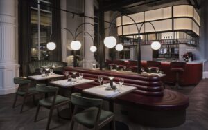 restaurant tables in front of central bar with suspended statement globe lighting above the tables by northern Lights