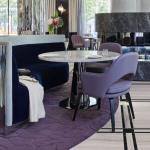 marble tables on purple tufted carpet in the royce hotel