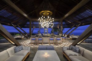 seating under a chandelier at the open air pool bar