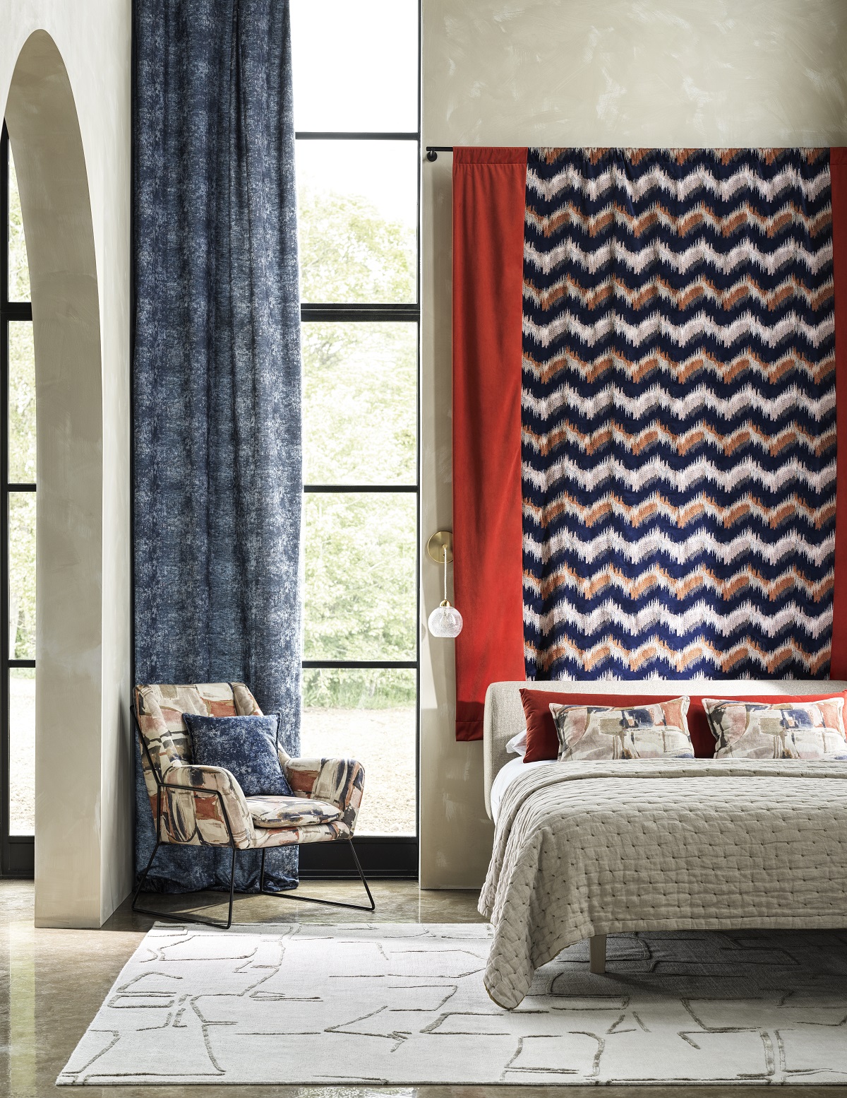 bedroom with floor to ceiling window next to bed and chevron fabric behind the bed