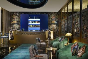 lounge in blue and green with velvet seating and bar detail at W Dubai - Mina Seyahi 