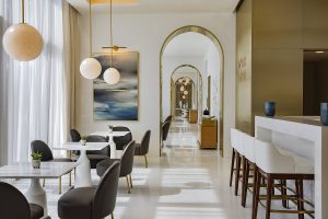 restaurant space with marble surfaces and round pearli like lights in spa restaurant at Espa Waldorf Astoria Doha