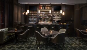 dark wood and low lighting in bar and seating area in Waldorf Astoria Orlando