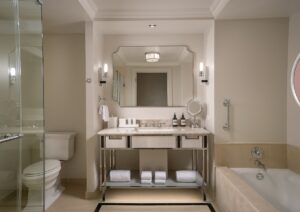 marble, cream and stone art deco inspired hotel bathroom